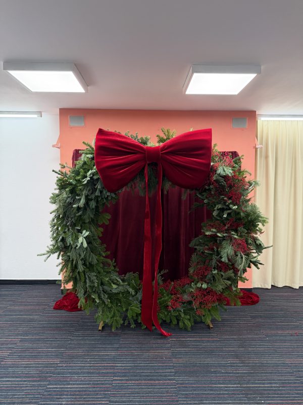 The VIP zone photo wall with the red bow and wreath