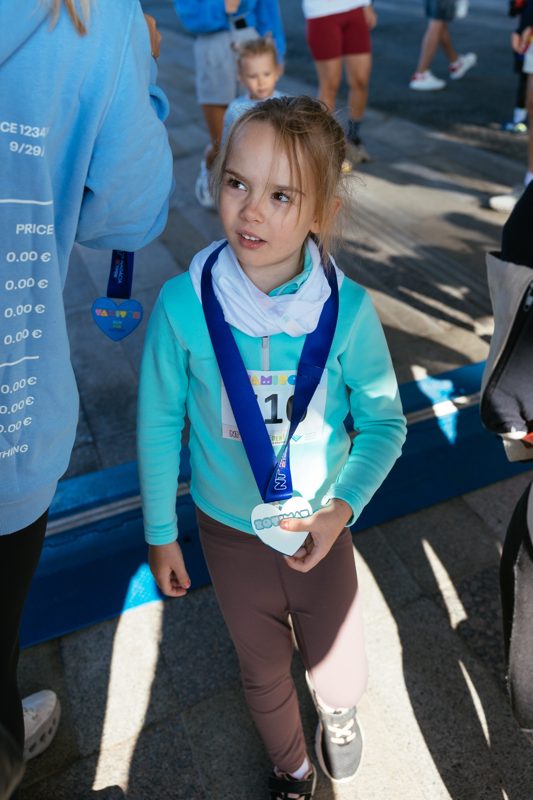 A girl with her medal at the finish