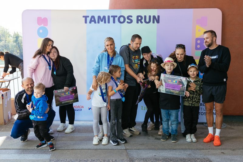 Families in front of the Tamitos Run photo wall